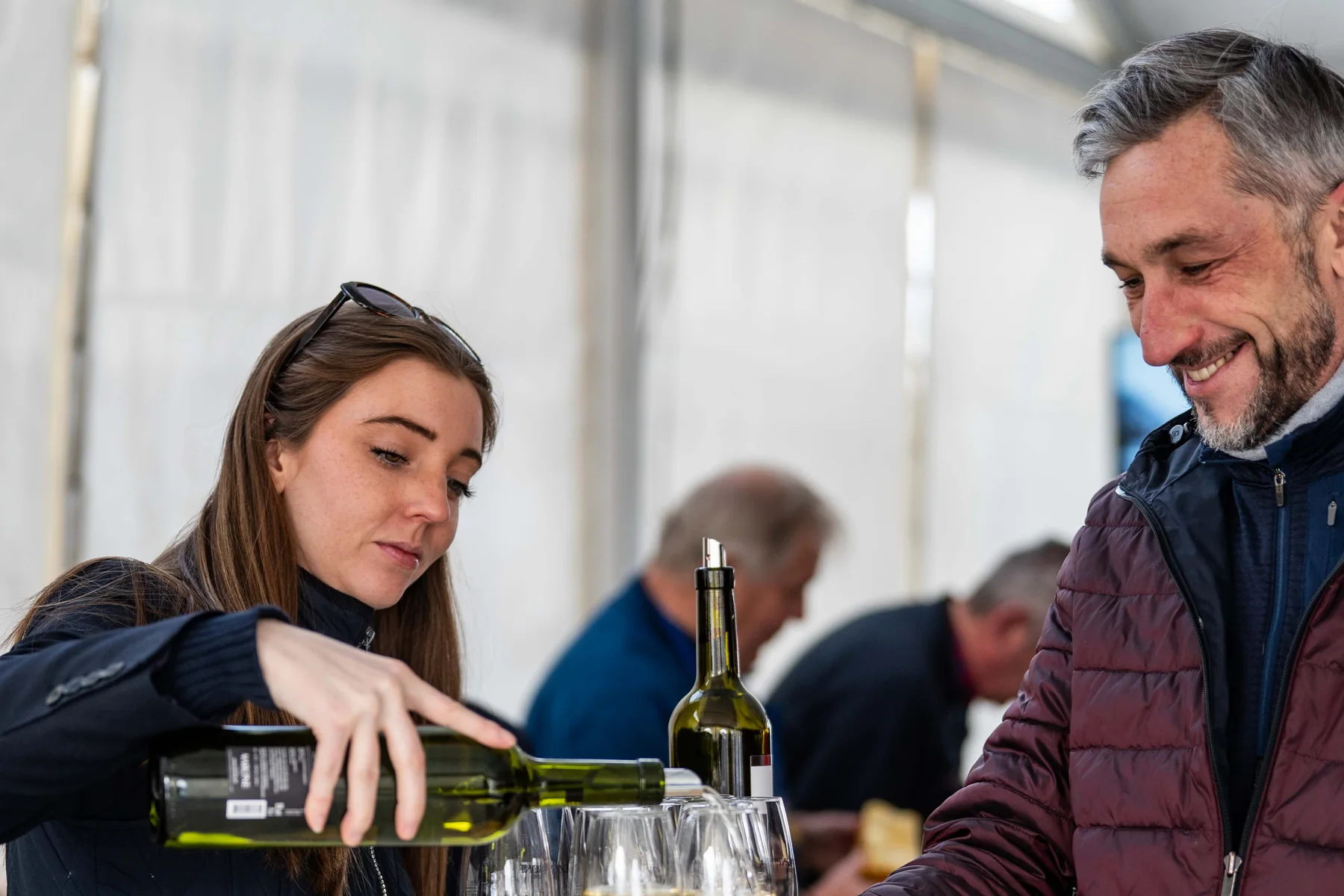 Serving wine to a guest in the hospitality area at the World Cup in Veysonnaz.